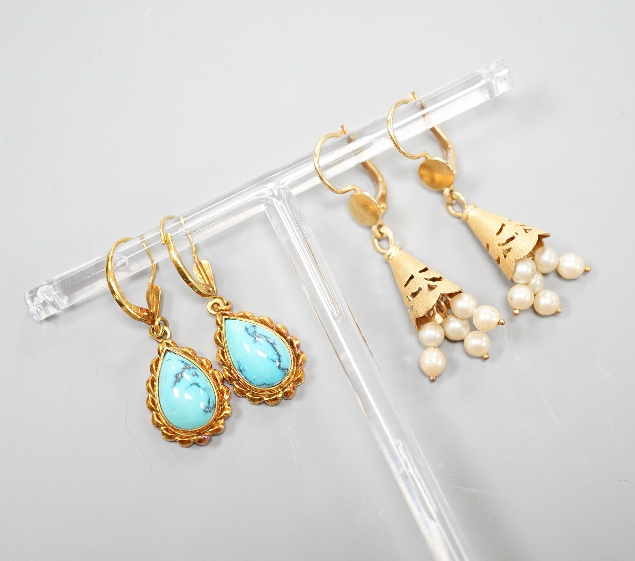 Two modern pairs of 18ct and gem set drop earrings, one with cultured pearl, 42mm and one with turquoise, gross weight 11.7 grams.